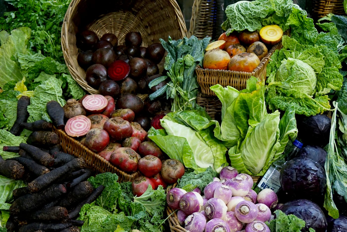 green and red vegetable on brown woven basket