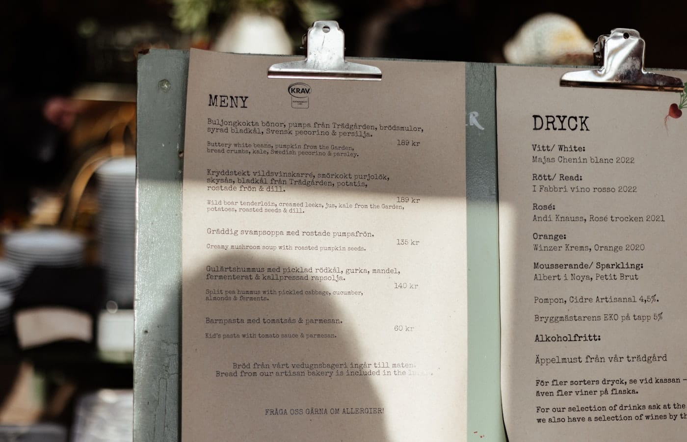 A menu sitting on top of a table next to a cup of coffee